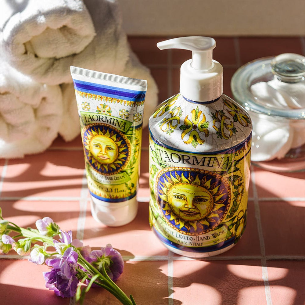 Laormina skincare products on a tiled surface with flowers and towels in the background